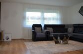 Bestandsfreies Mehrfamilienhaus mit zwei Grundstücken in Feldkirch zu verkaufen - Wohnzimer 2 bearbeitet